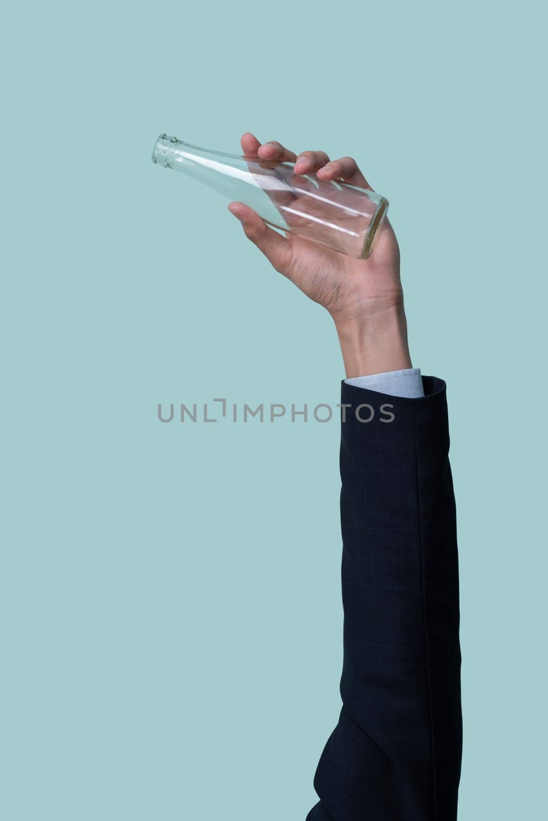 Businessman's hand holding glass bottle on isolated background. Eco-business recycle waste policy in corporate responsibility. Reuse, reduce and recycle for sustainability environment. Quaint