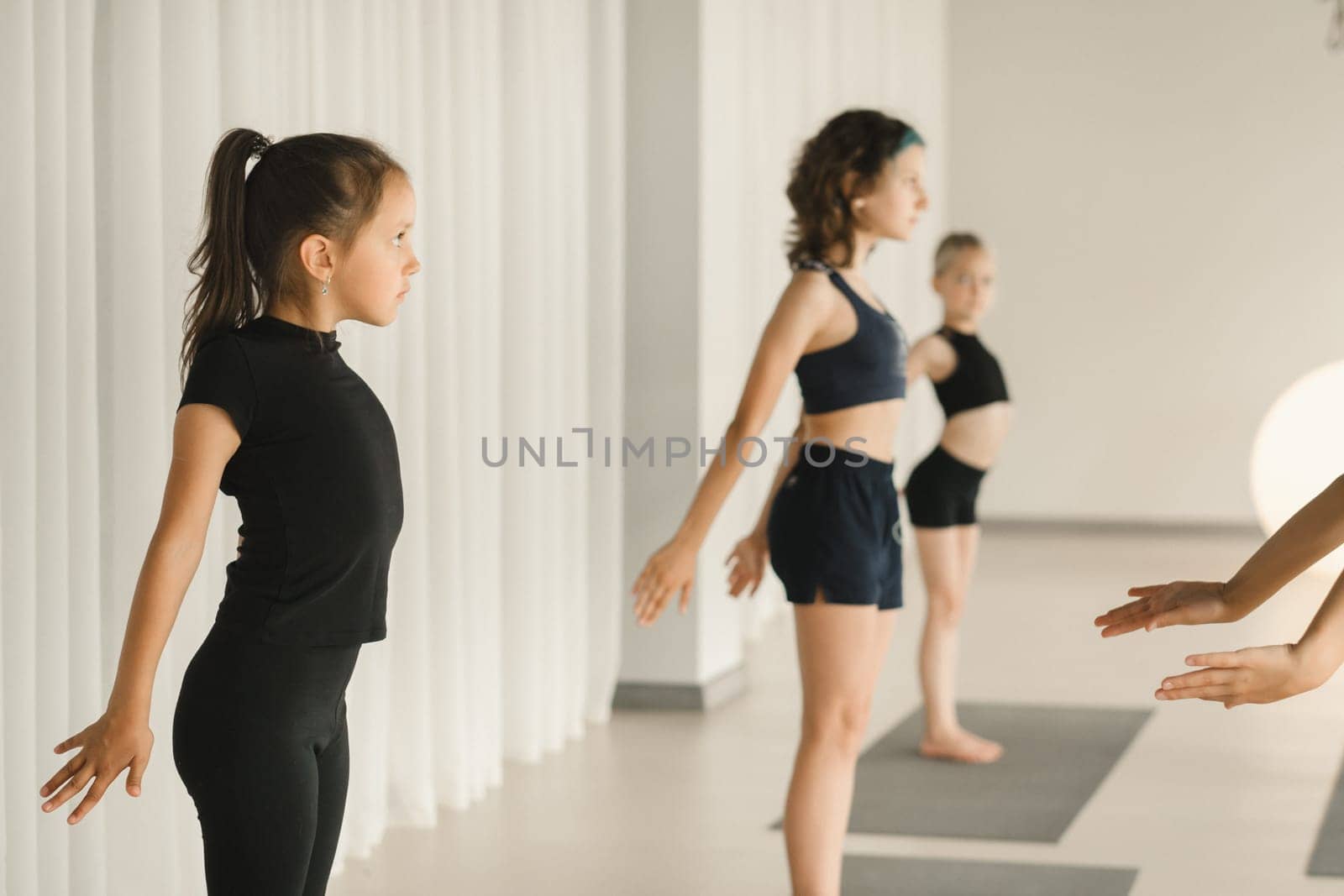 Children do Yoga in the fitness room. Children's gymnastics by Lobachad