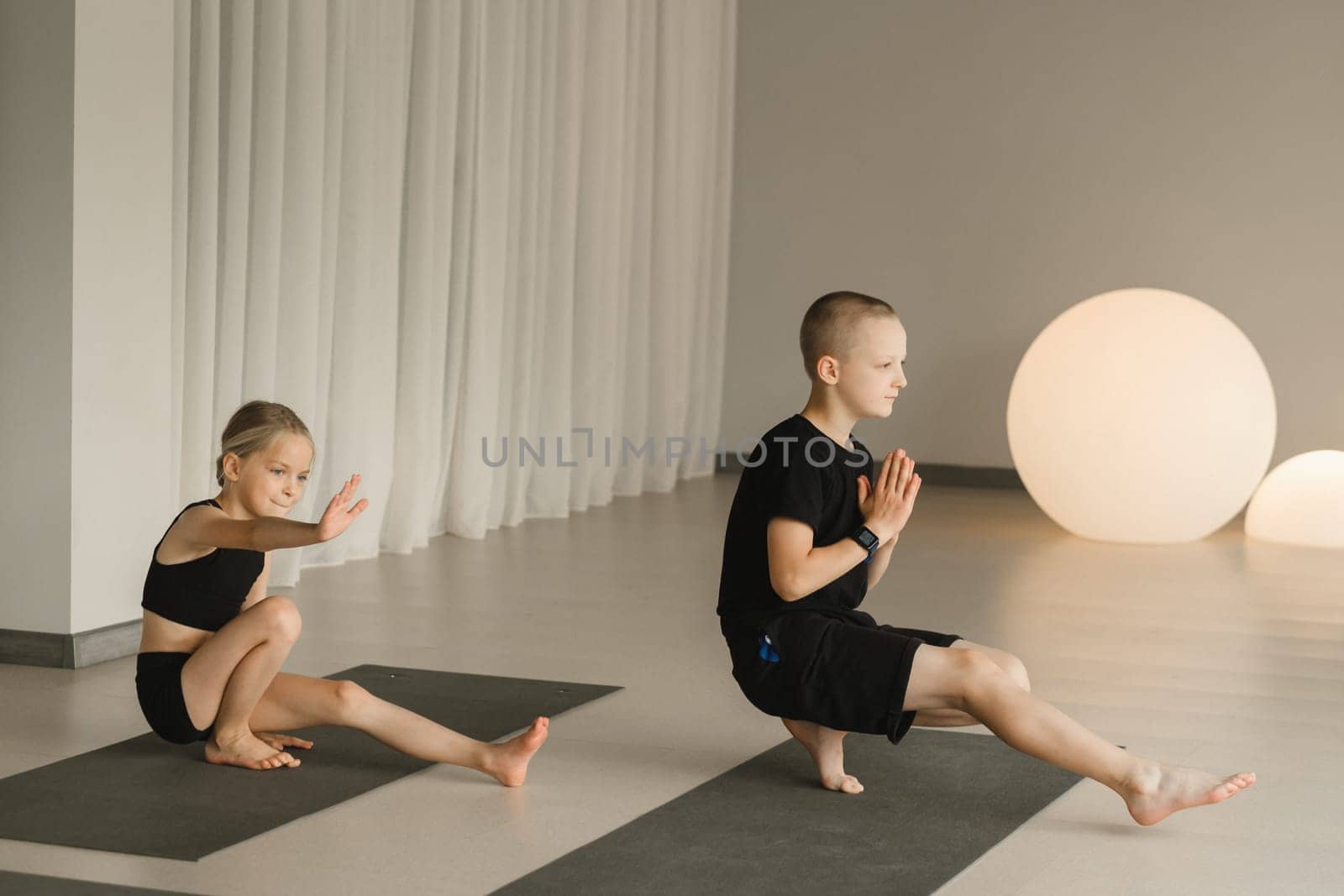 Children do Yoga in the fitness room. Children's gymnastics.