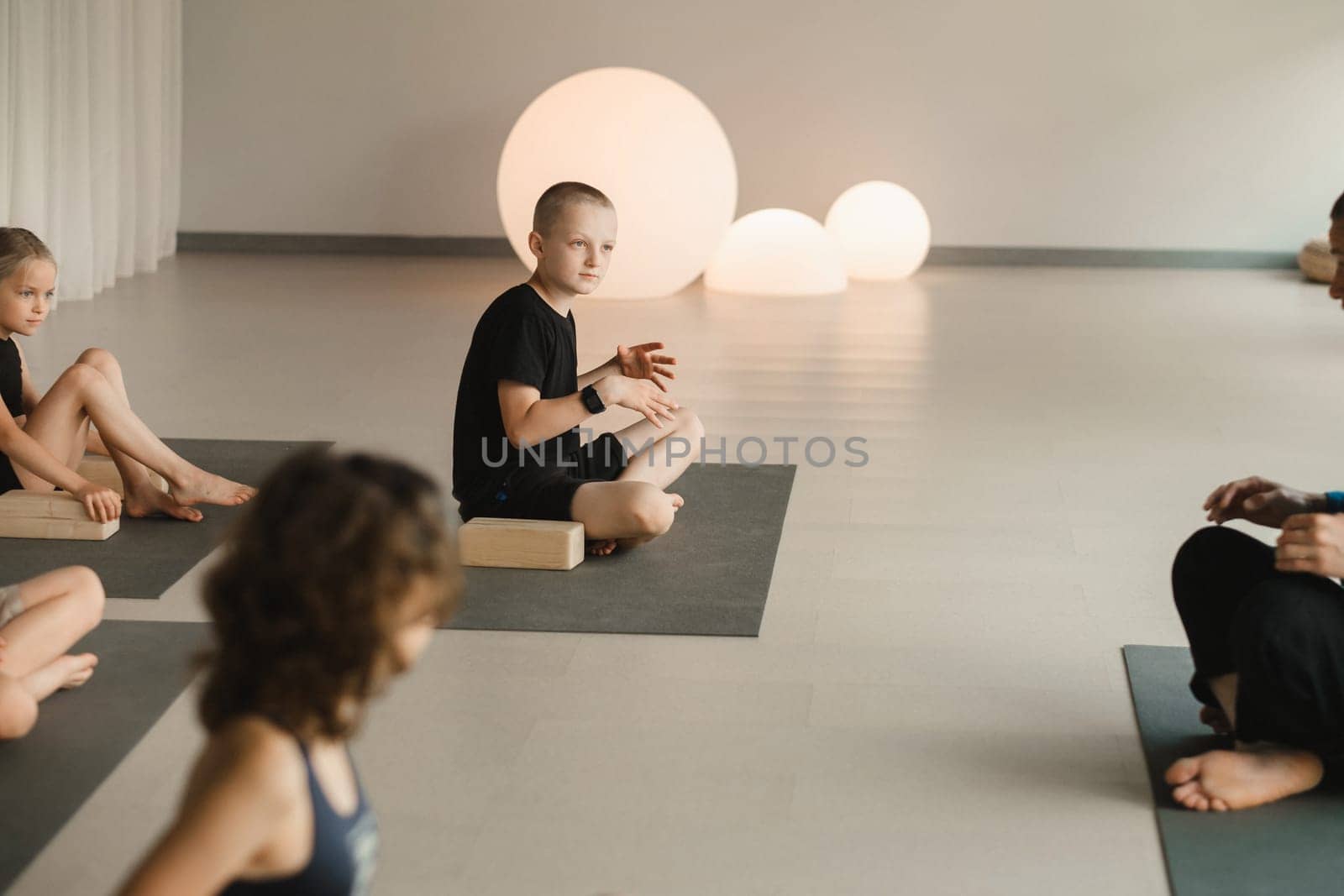 Children do yoga in the gym on support blocks. Children's gymnastics.