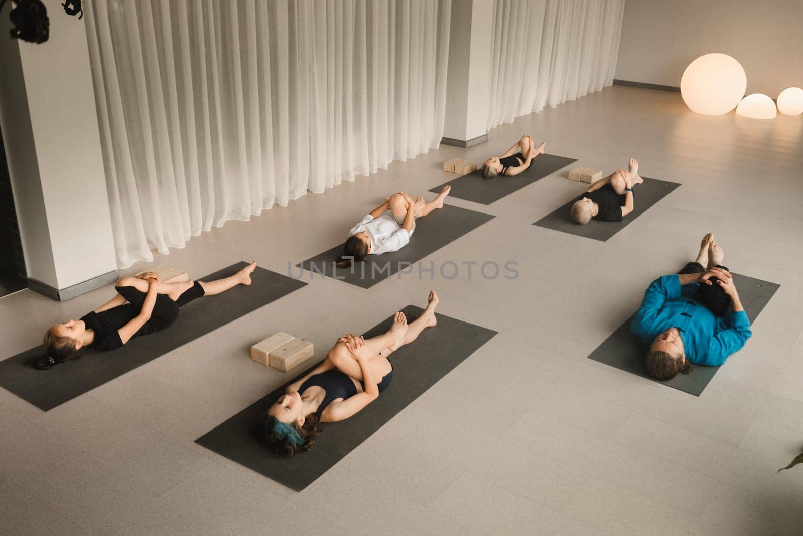 Children do yoga in the gym under the guidance of an instructor. Children's gymnastics.