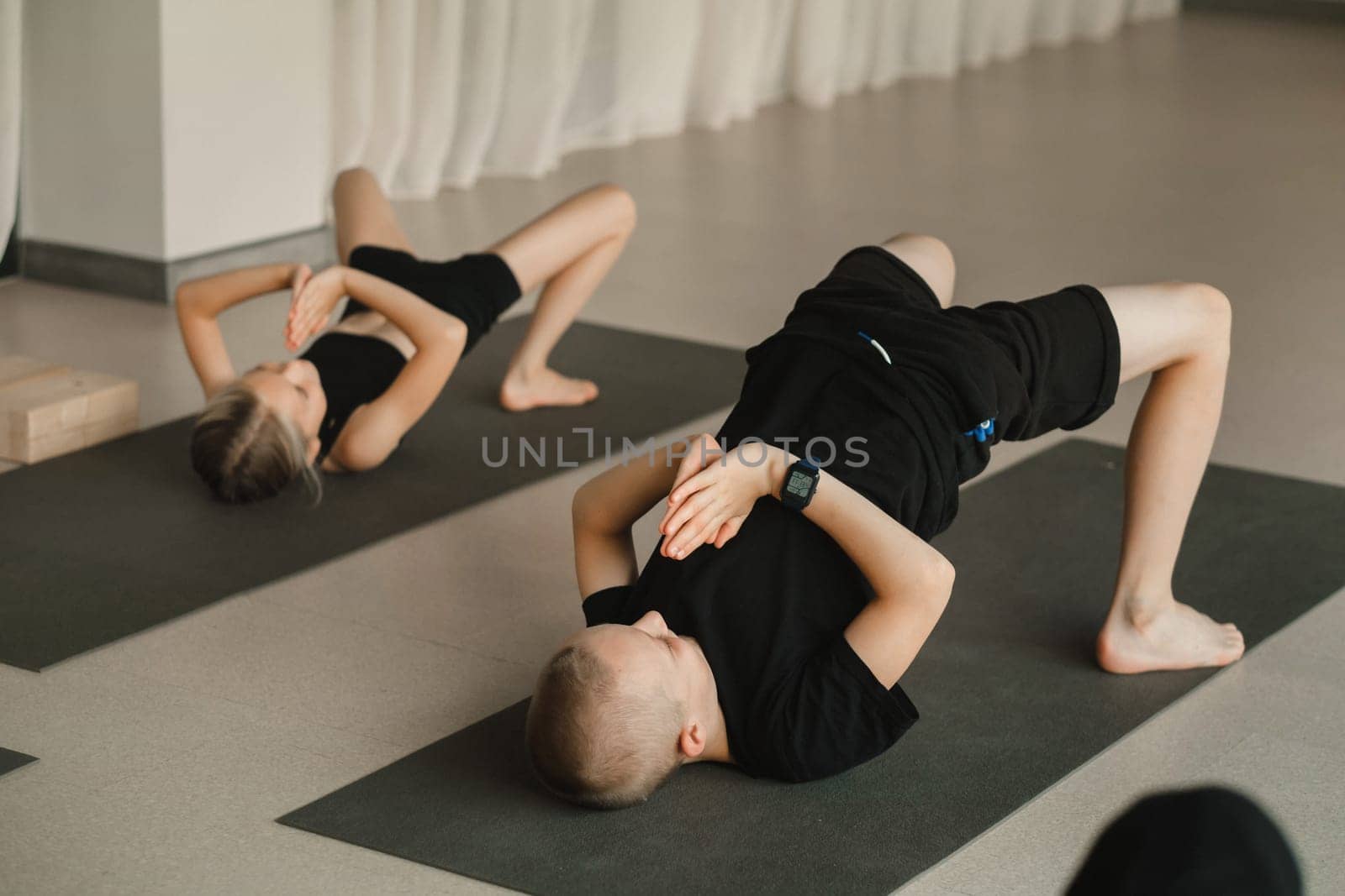 Children do Yoga in the fitness room. Children's gymnastics.