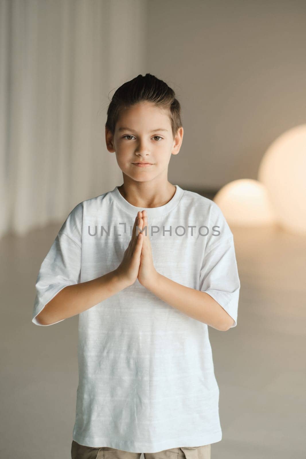 A child practices yoga poses indoors. Children's yoga.