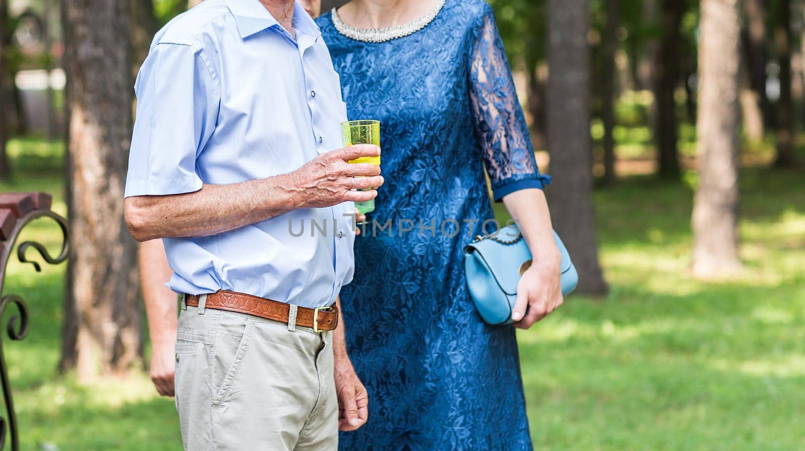 senior couple with glass of champagne outdoors by Satura86