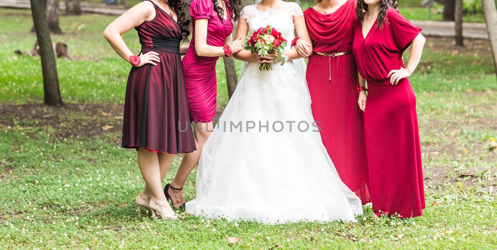 Bride with bridesmaids outdoors on the wedding day by Satura86