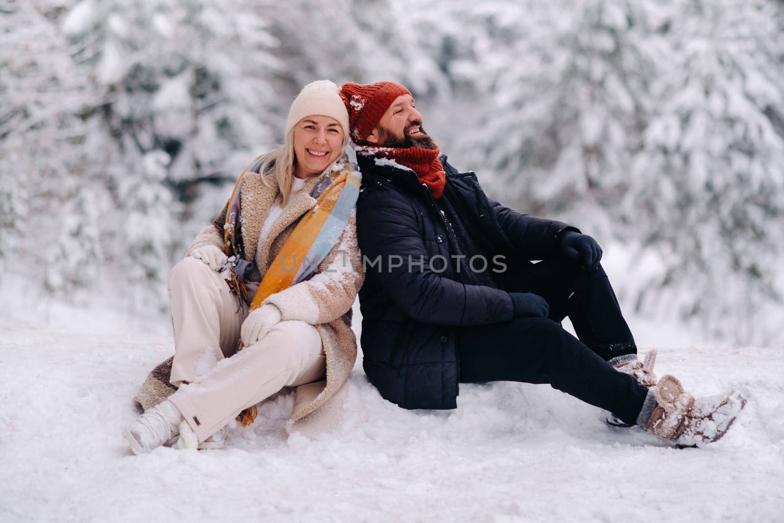 A cheerful couple, a man and a woman on the street in the snowy season.