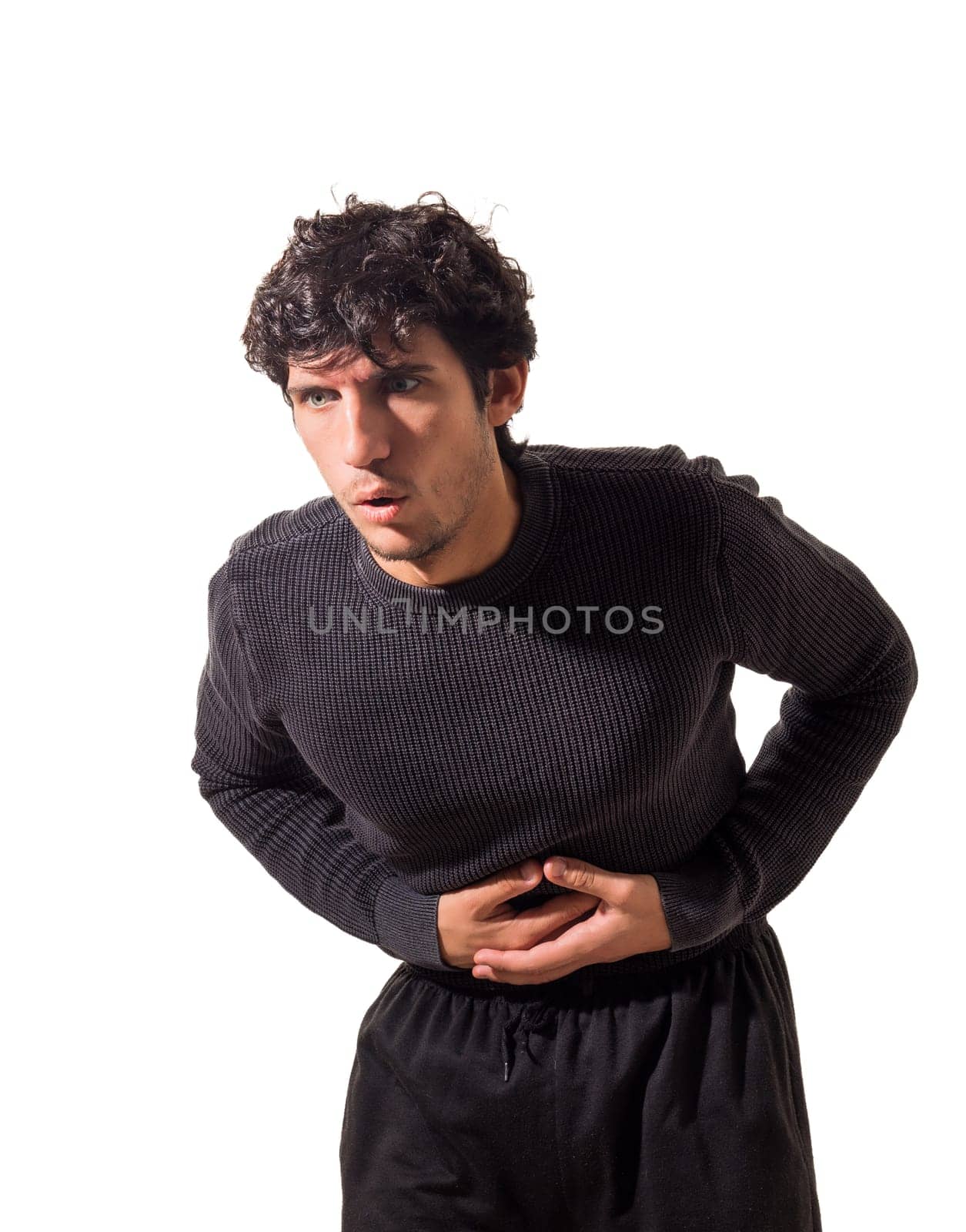 Confident Young Man Striking a Pose With His Hands on His Stomach, Feeling Unwell, Having a Aching Belly, Illness