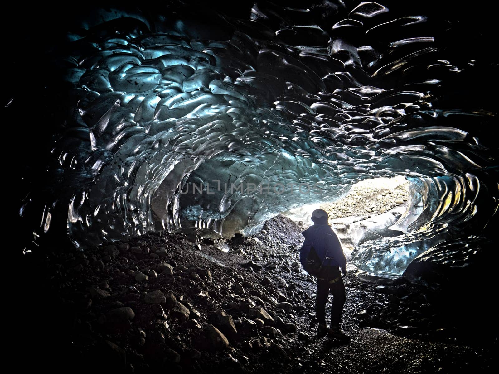 man exploring an ice cave in Iceland