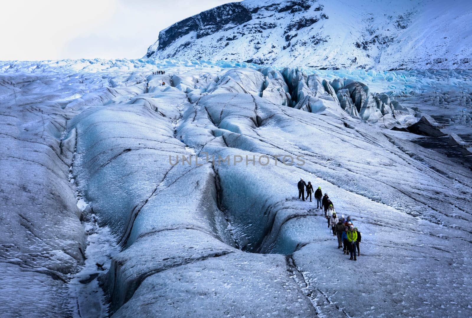 A group of people standing on a glacier