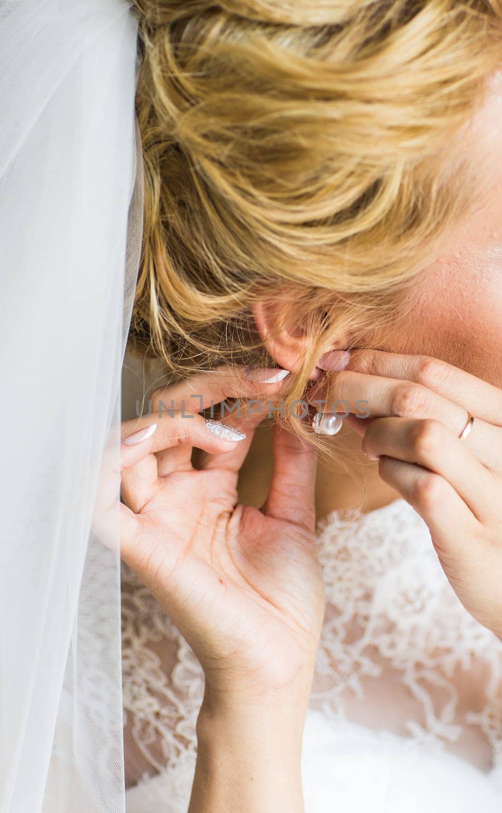 close-up of beautiful woman wearing shiny diamond earrings.