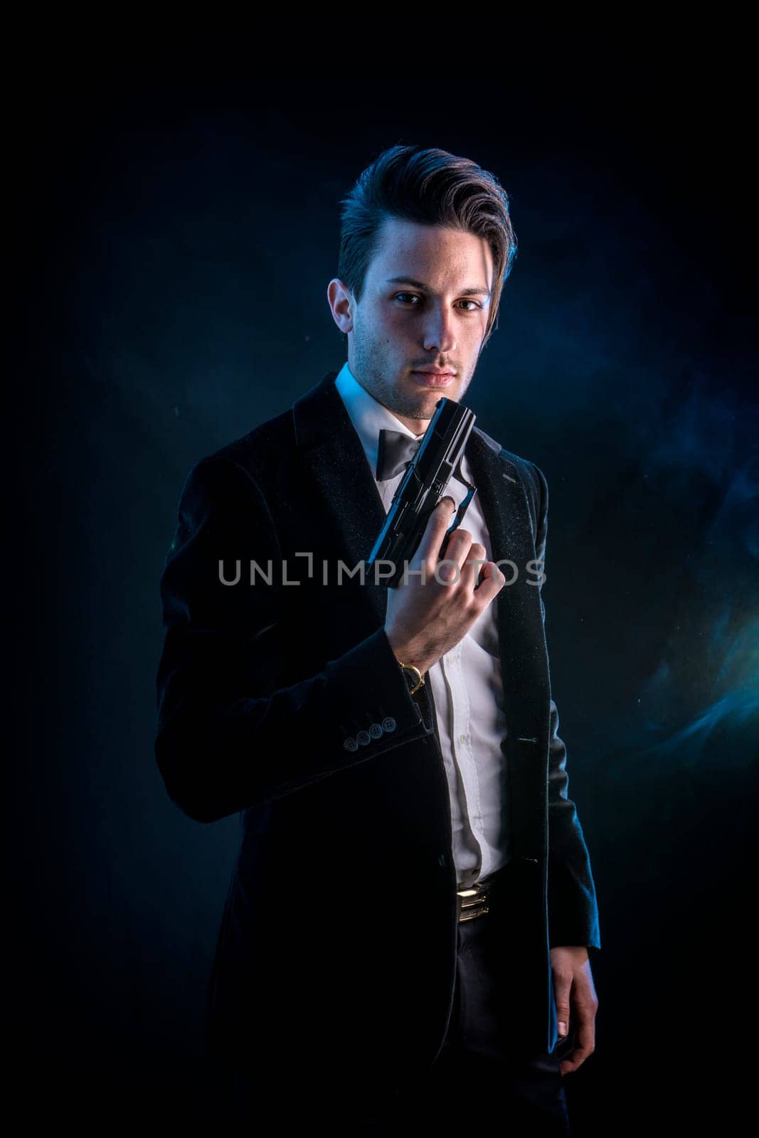 Photo of a man in a formal attire holding a firearm by artofphoto