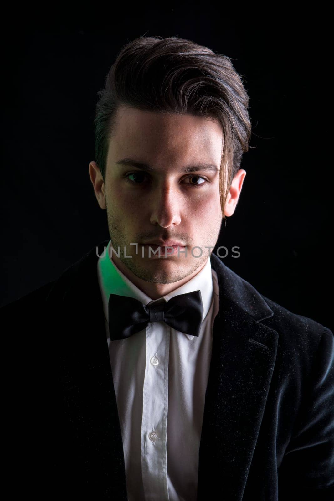 Photo of a stylish man in a suit and bow tie by artofphoto