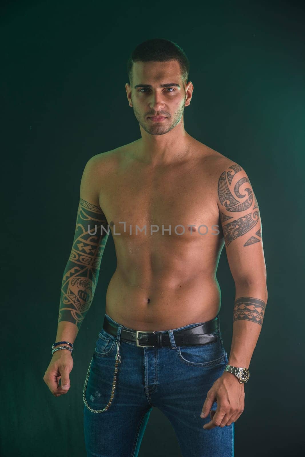 Photo of a handsome man showing off his tattooed arm by artofphoto