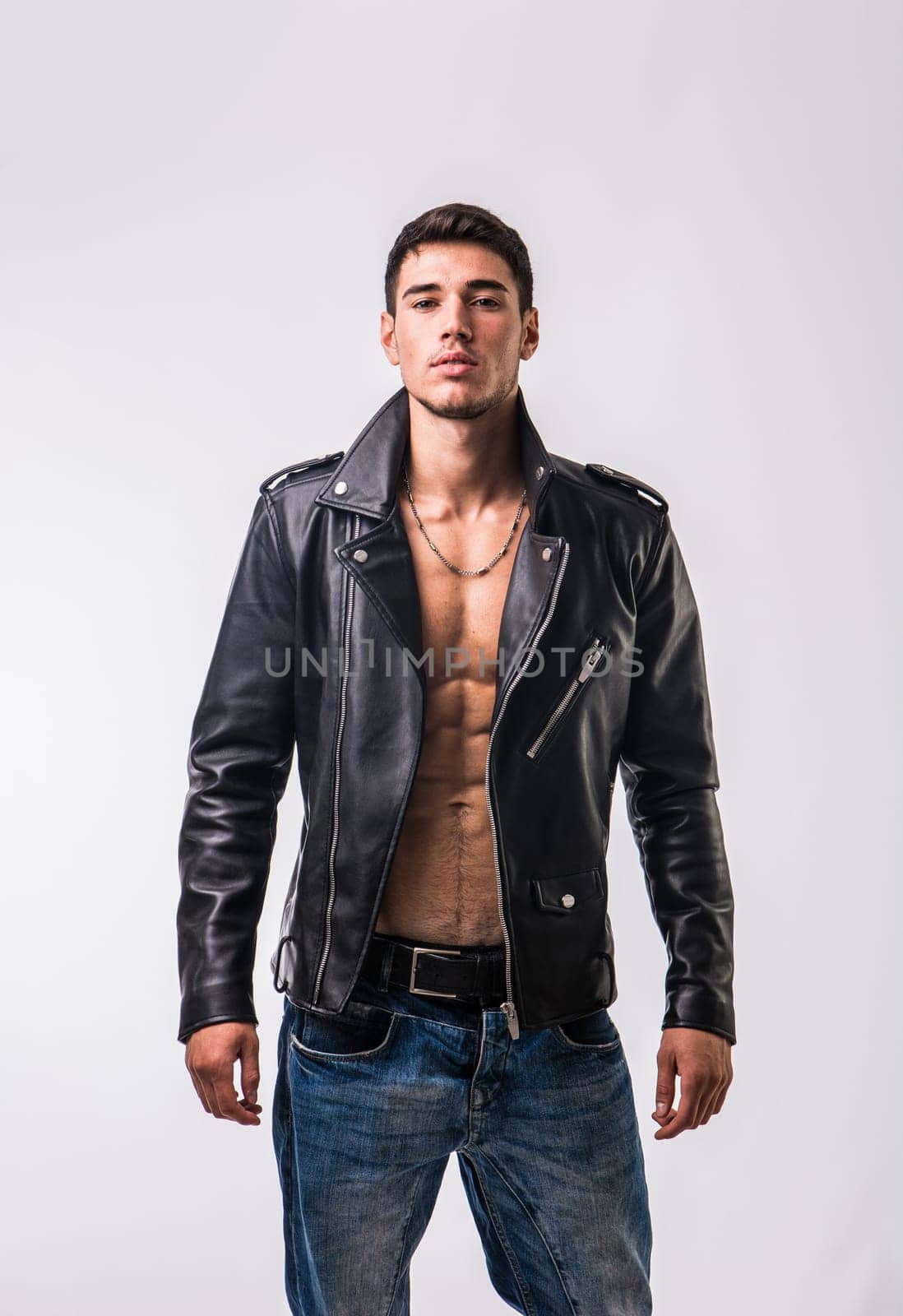 Photo of a stylish man in a leather jacket posing for a portrait by artofphoto