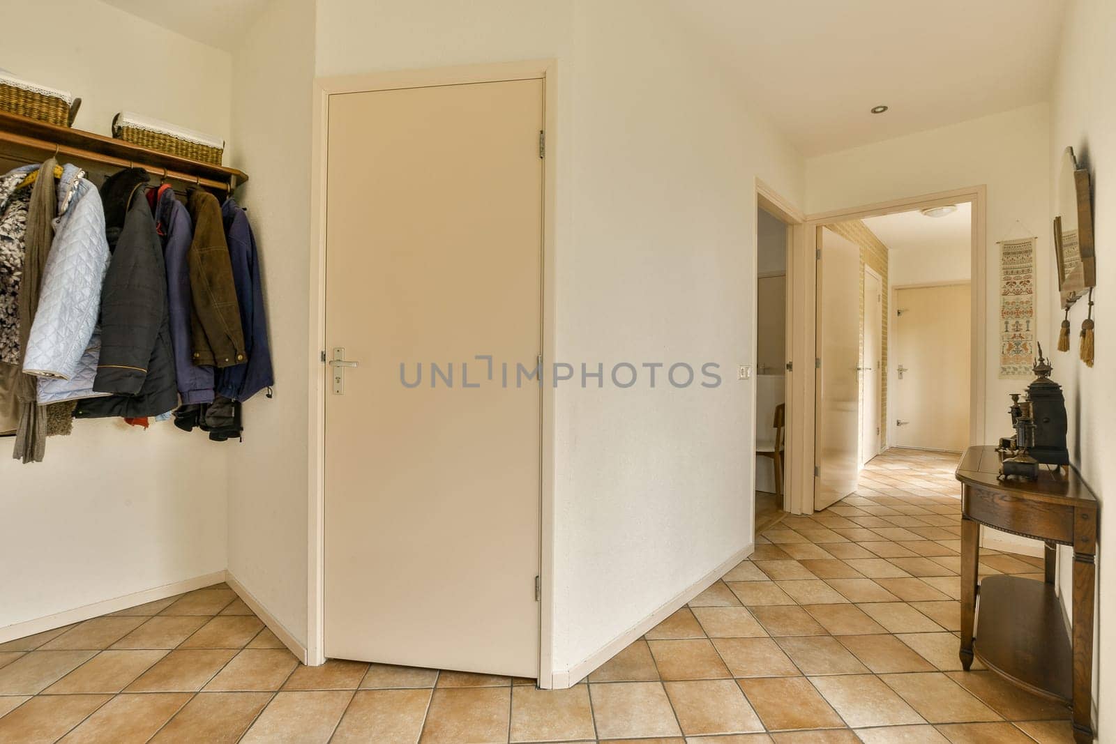 the inside of a room with clothes hanging on hooks and closets in it, as well to be used