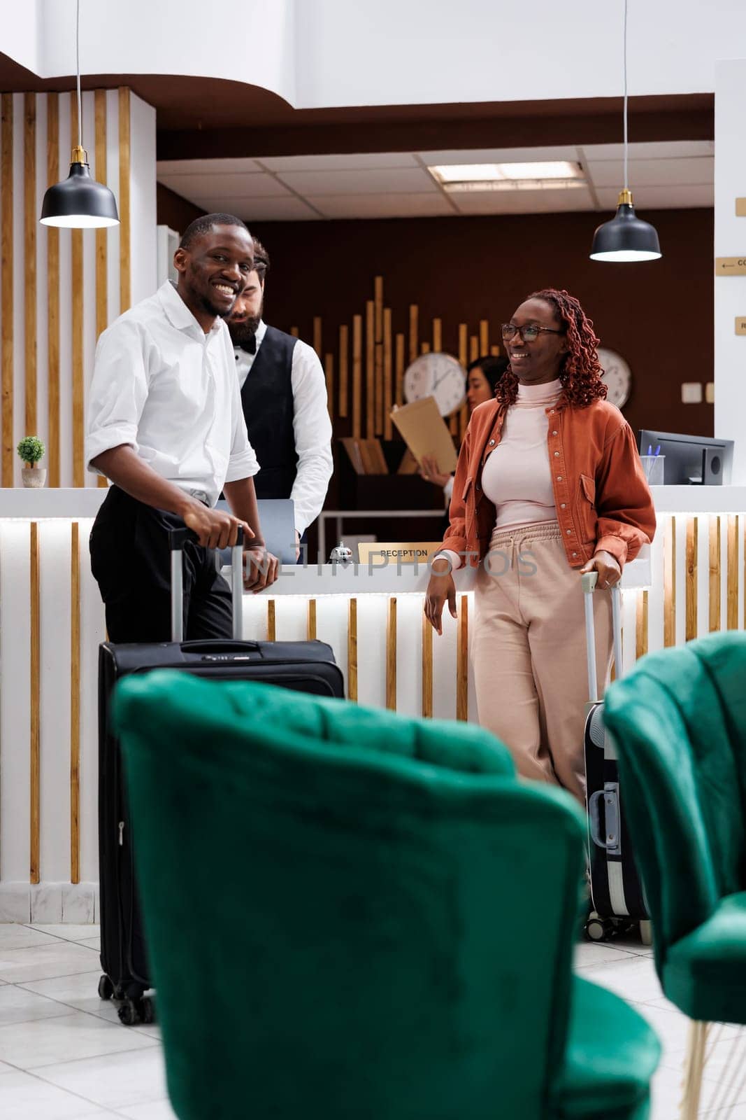 African american couple at front desk by DCStudio