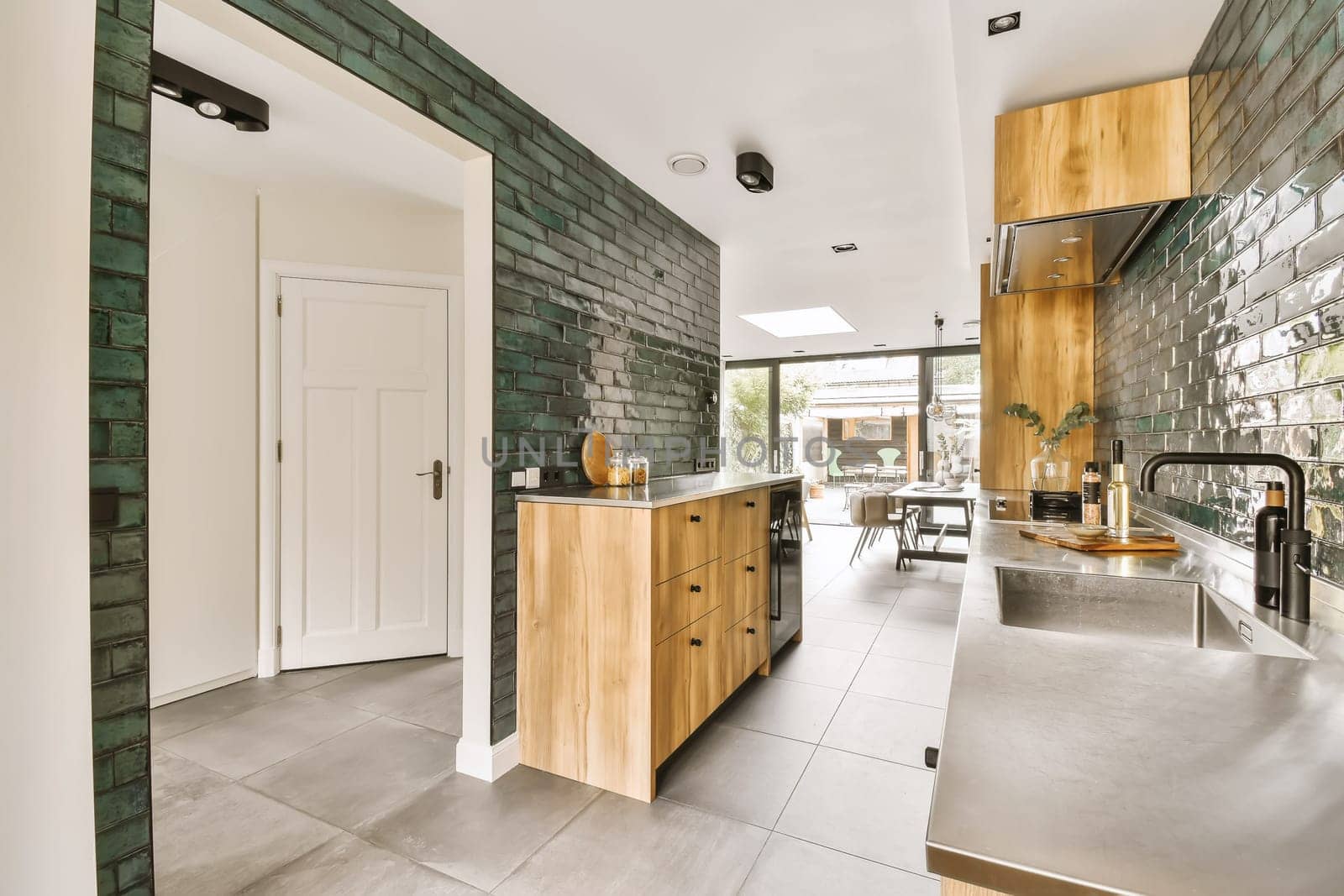 a kitchen with a large counter top and a sink by casamedia