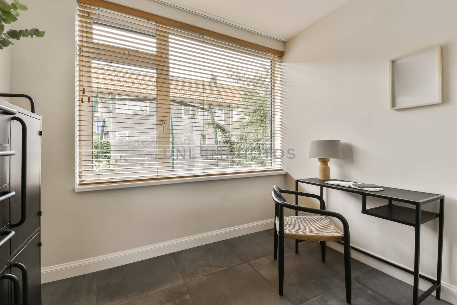 a living room with a desk and a large window by casamedia