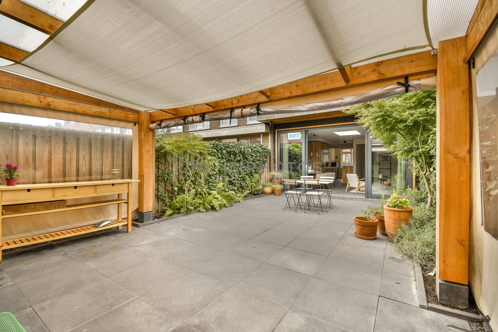 the patio of a home with a wooden porch and by casamedia