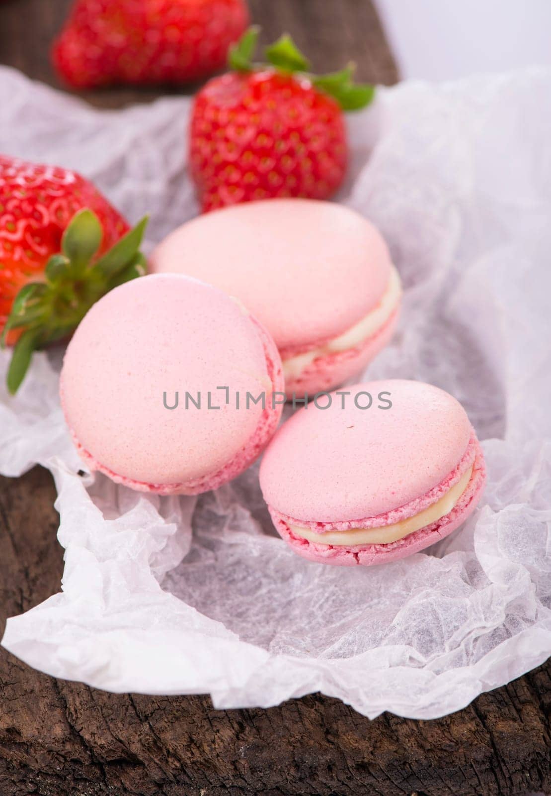 Macaroon with berries cookies on a wooden background