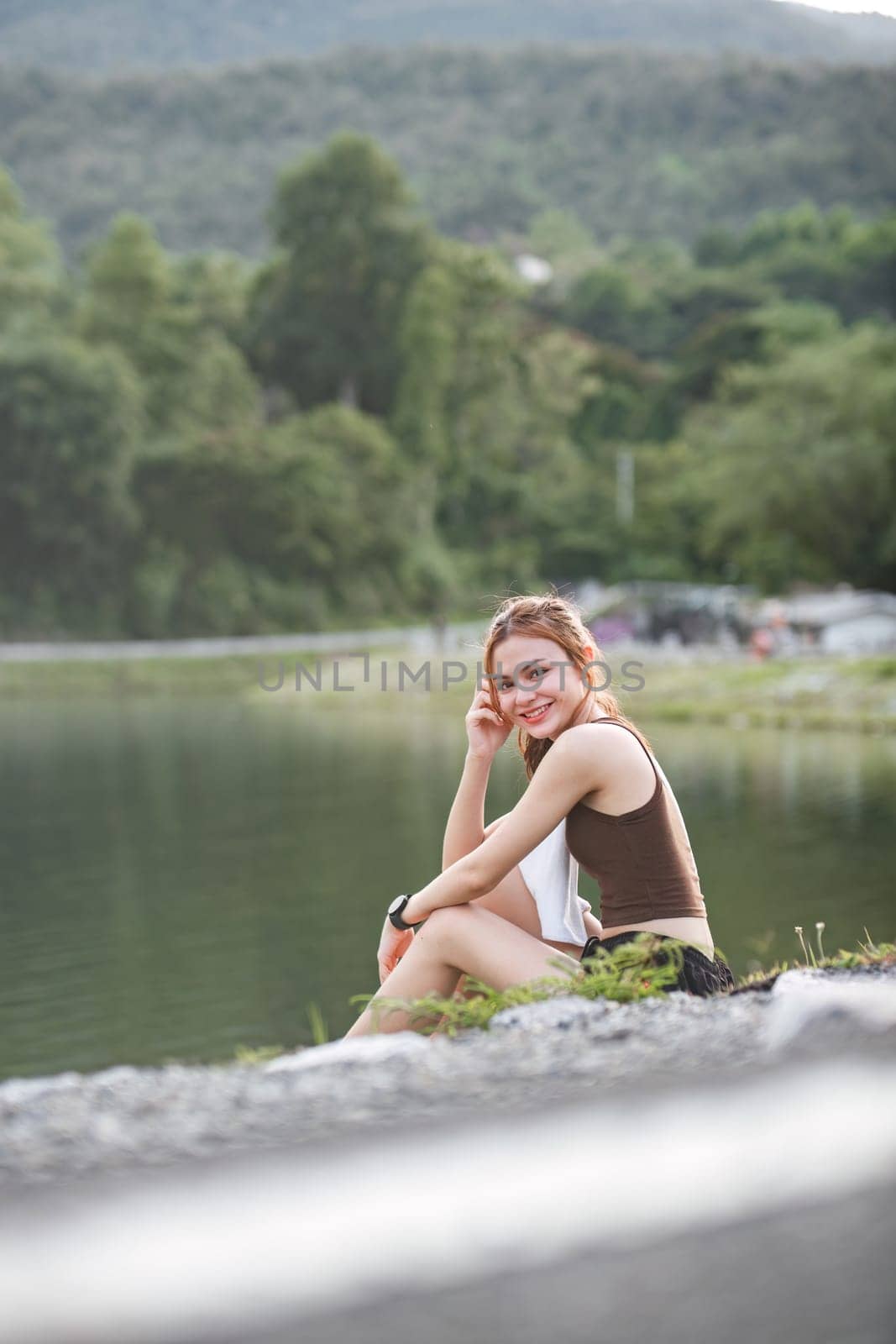 portrait of beautiful asian woman Wipe off your sweat after an evening jog in the park..