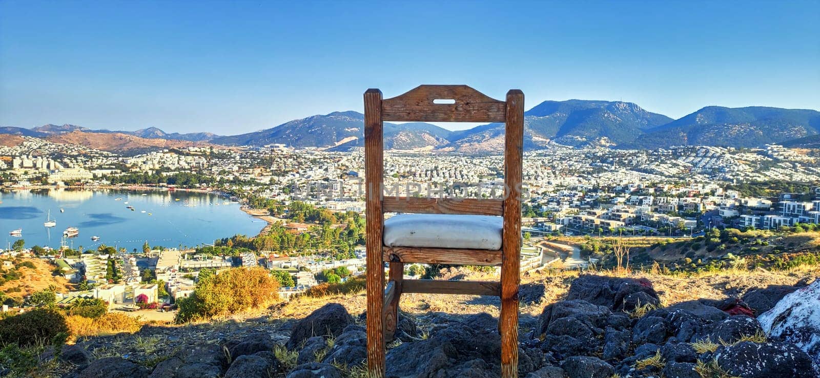 wooden chair standing on the top city on the background download photo