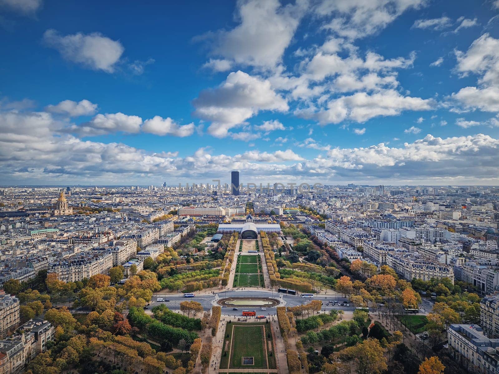Paris cityscape view from the Eiffel tower heights, France. Montparnasse tower and Les Invalides seen on the horizon panorama. Beautiful autumn colors by psychoshadow