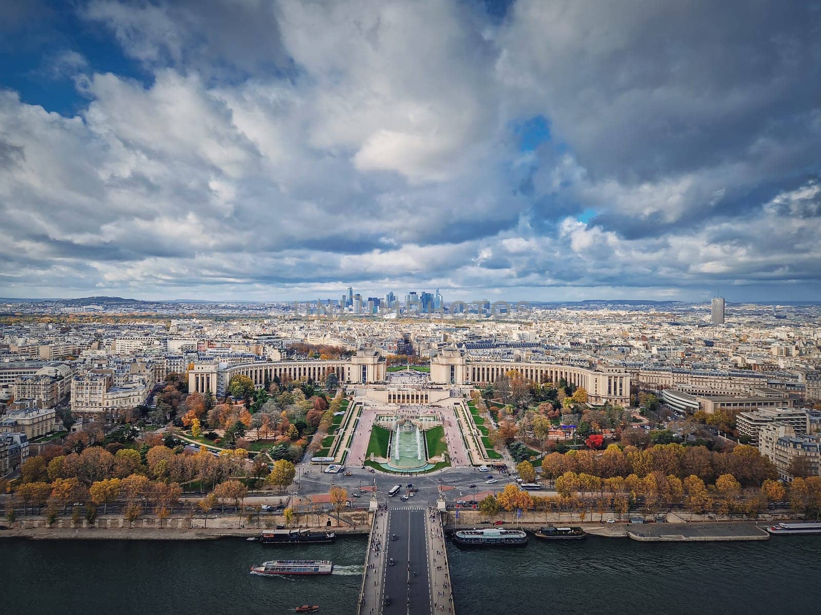 Aerial panoramic view from the Eiffel tower height to the Paris cityscape, France. Seine river, Trocadero area and La Defense metropolitan district seen on the horizon by psychoshadow