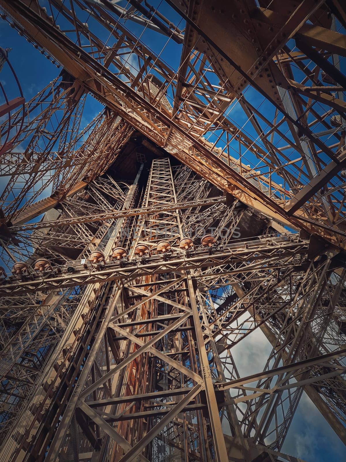Eiffel Tower architecture details Paris, France. Underneath the metallic structure, steel elements with different geometric shapes