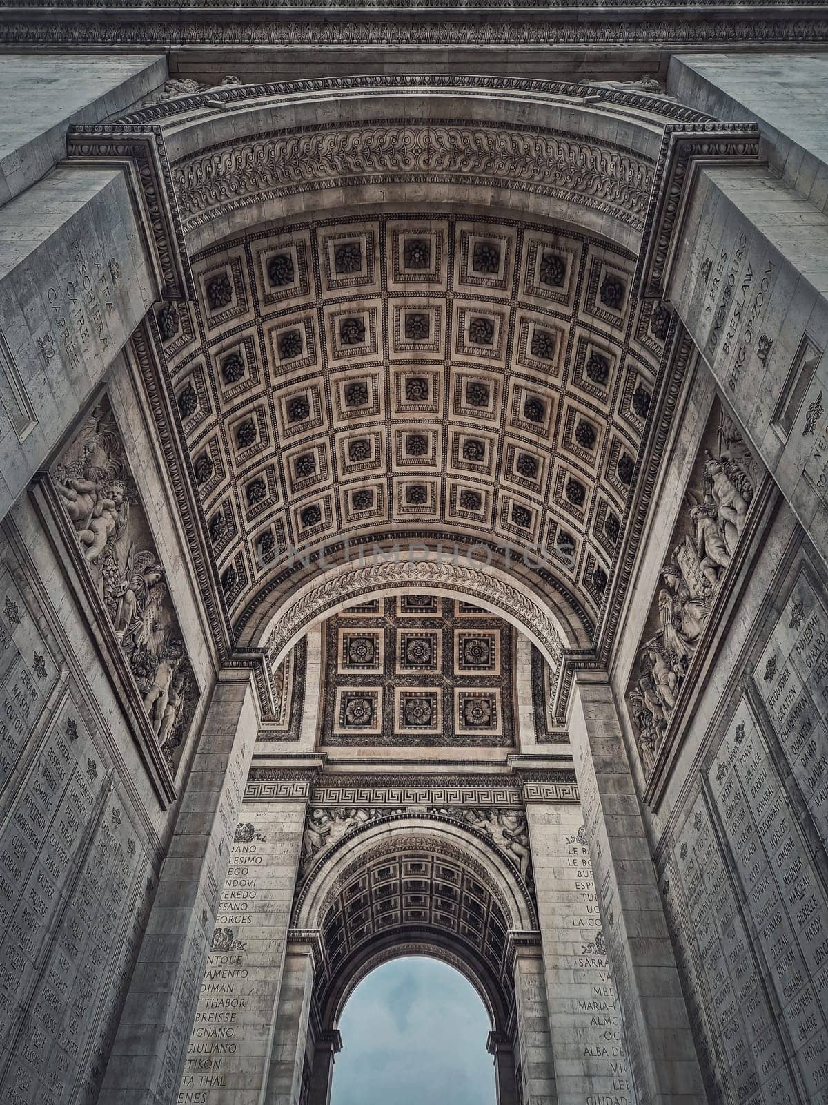 View underneath triumphal Arch (Arc de triomphe) in Paris, France. Architectural details of the famous historic landmark	 by psychoshadow