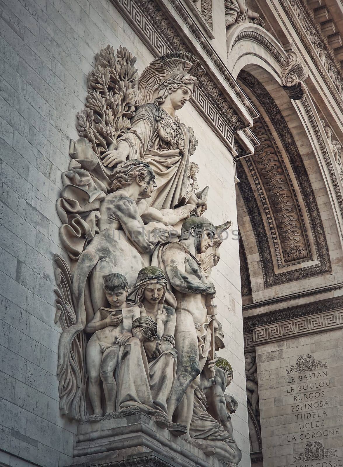 Closeup architectural details of the triumphal Arch, Paris, France. The peace statue (La Paix de 1815) adorns a pillar of the Arc de Triomphe with goddess of victory Minerva by psychoshadow