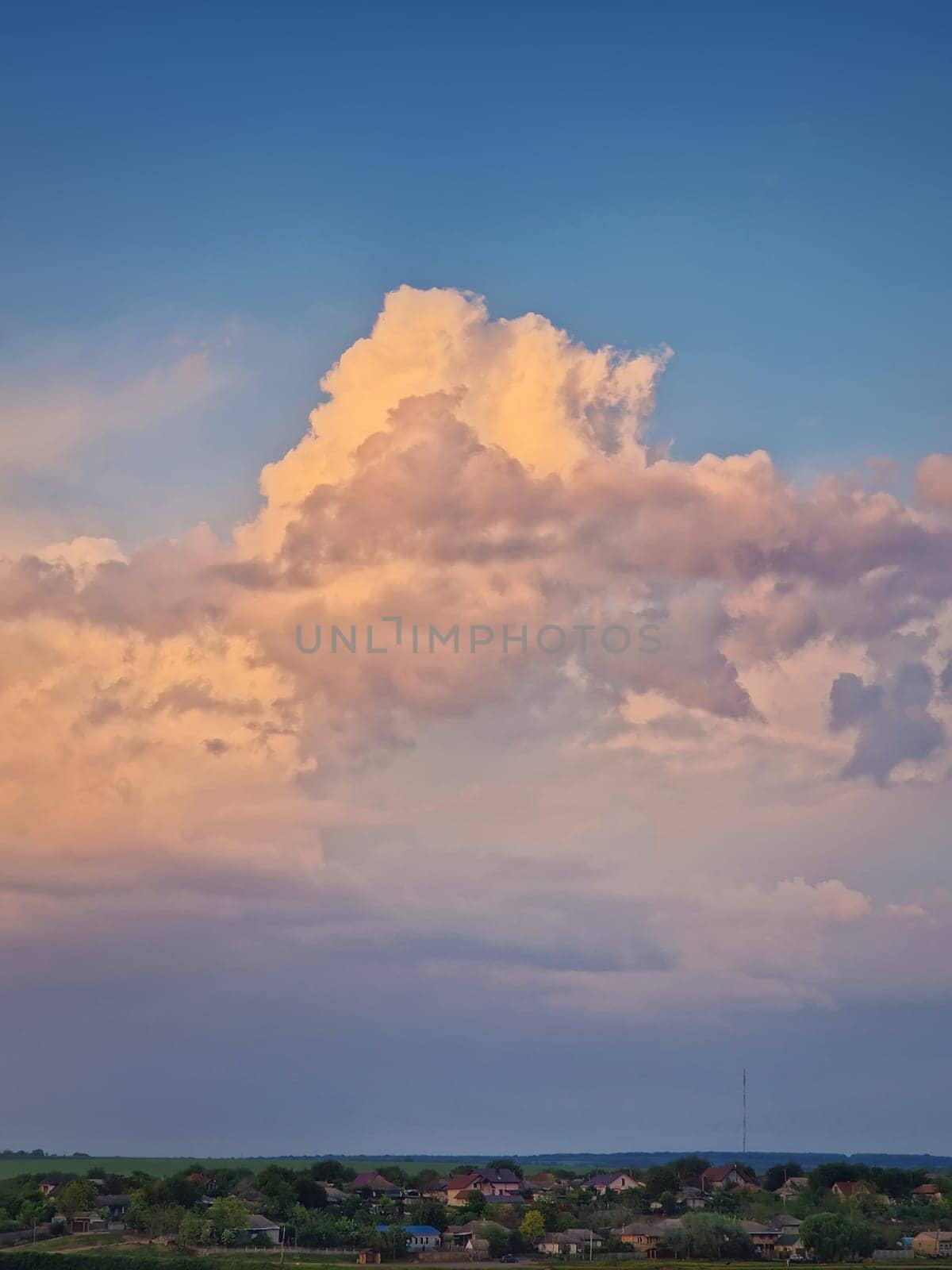 Beautiful clouds over the village. Countryside vertical background