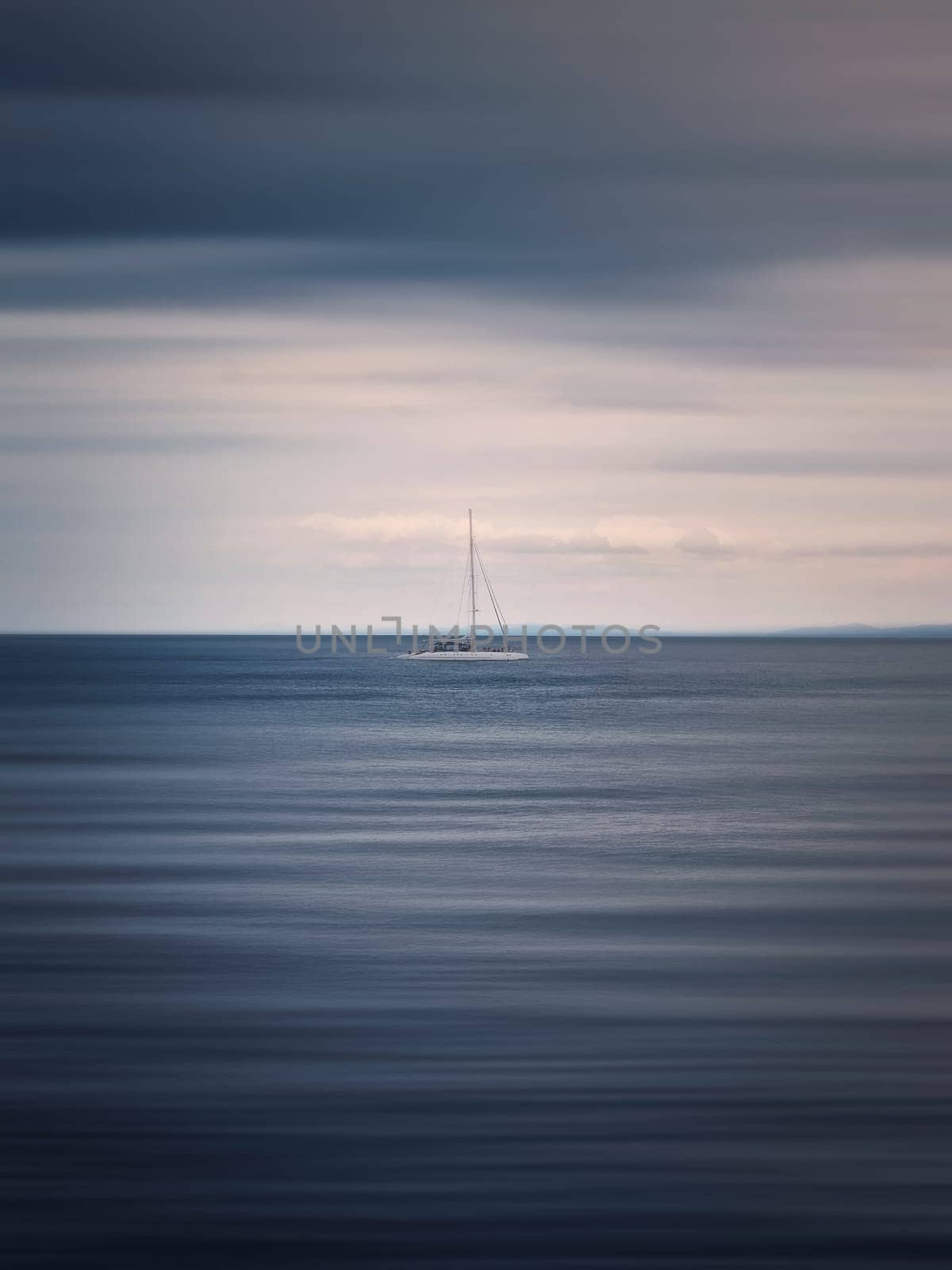 Seascape with a sailboat on the horizon, motion blur effect by psychoshadow