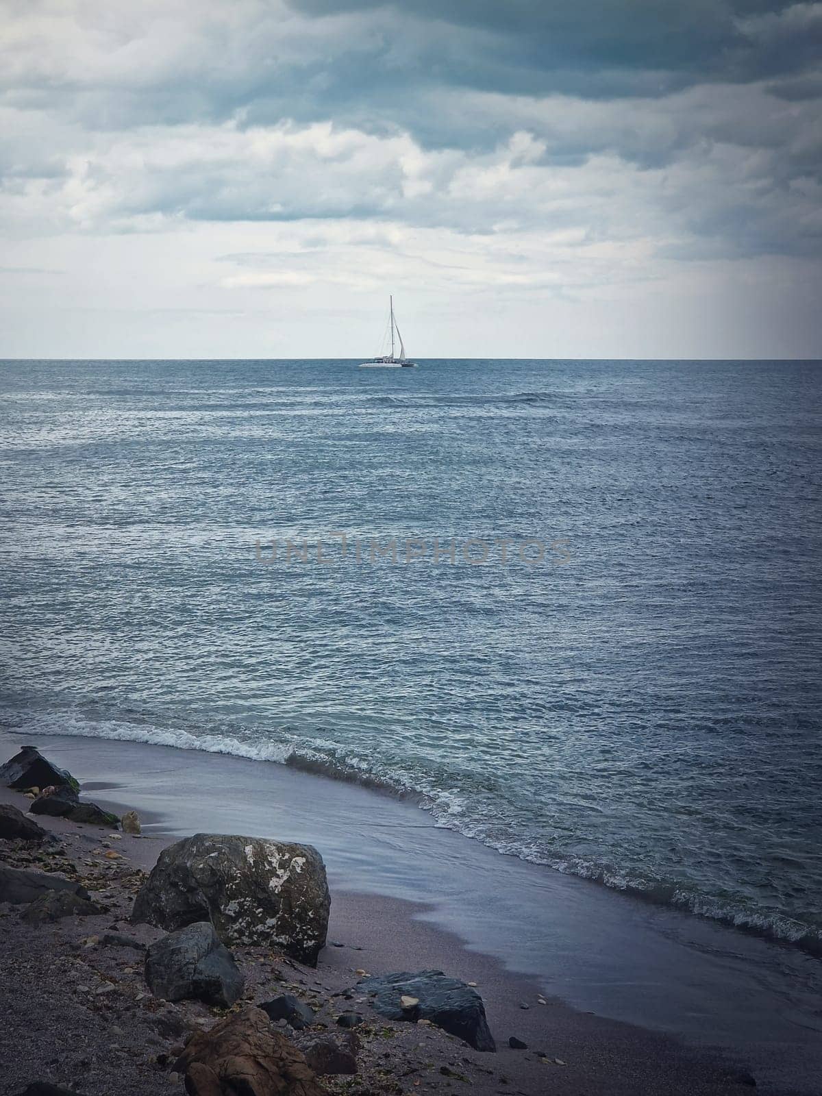 Seascape with a sailboat on the horizon. Bulgarian coastline of the Black Sea by psychoshadow