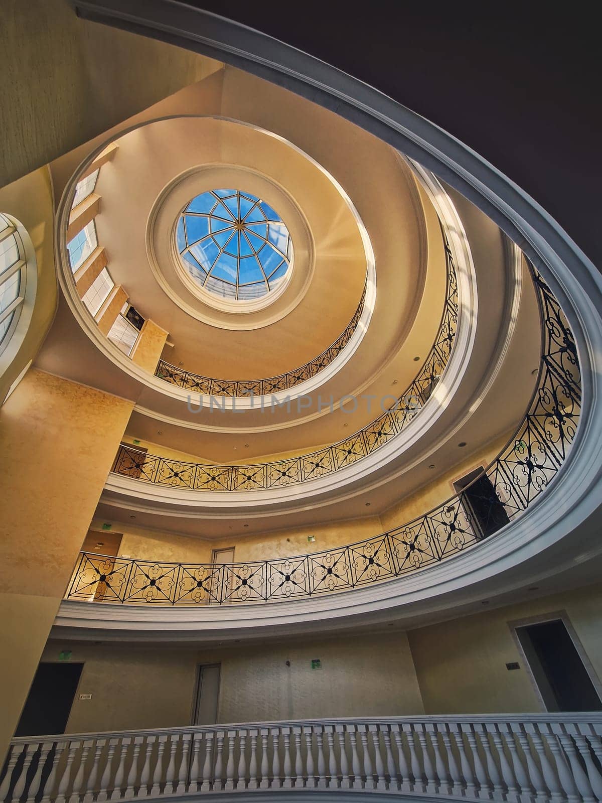 Upwards view architecture interior details of a big round storied hall with glass dome by psychoshadow