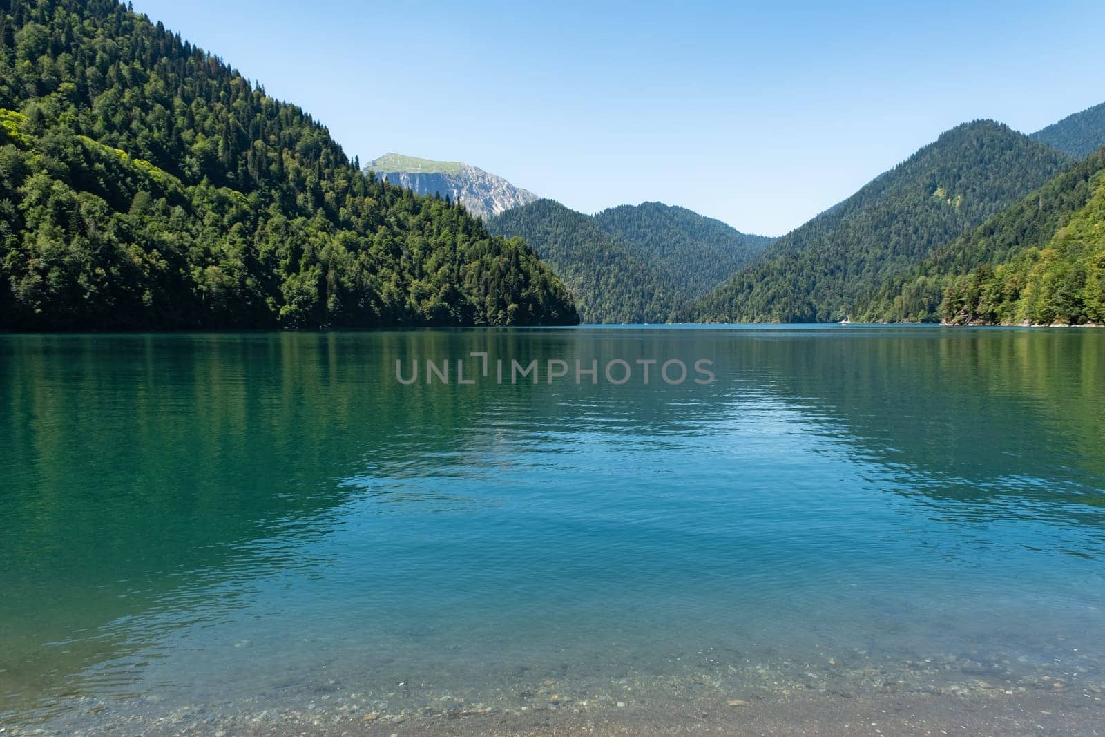 Beautiful mountain Lake Ritsa. Lake Ritsa in the Caucasus Mountains, in the north-western part of Abkhazia, Georgia, surrounded by mixed mountain forests and subalpine meadows by NataliPopova