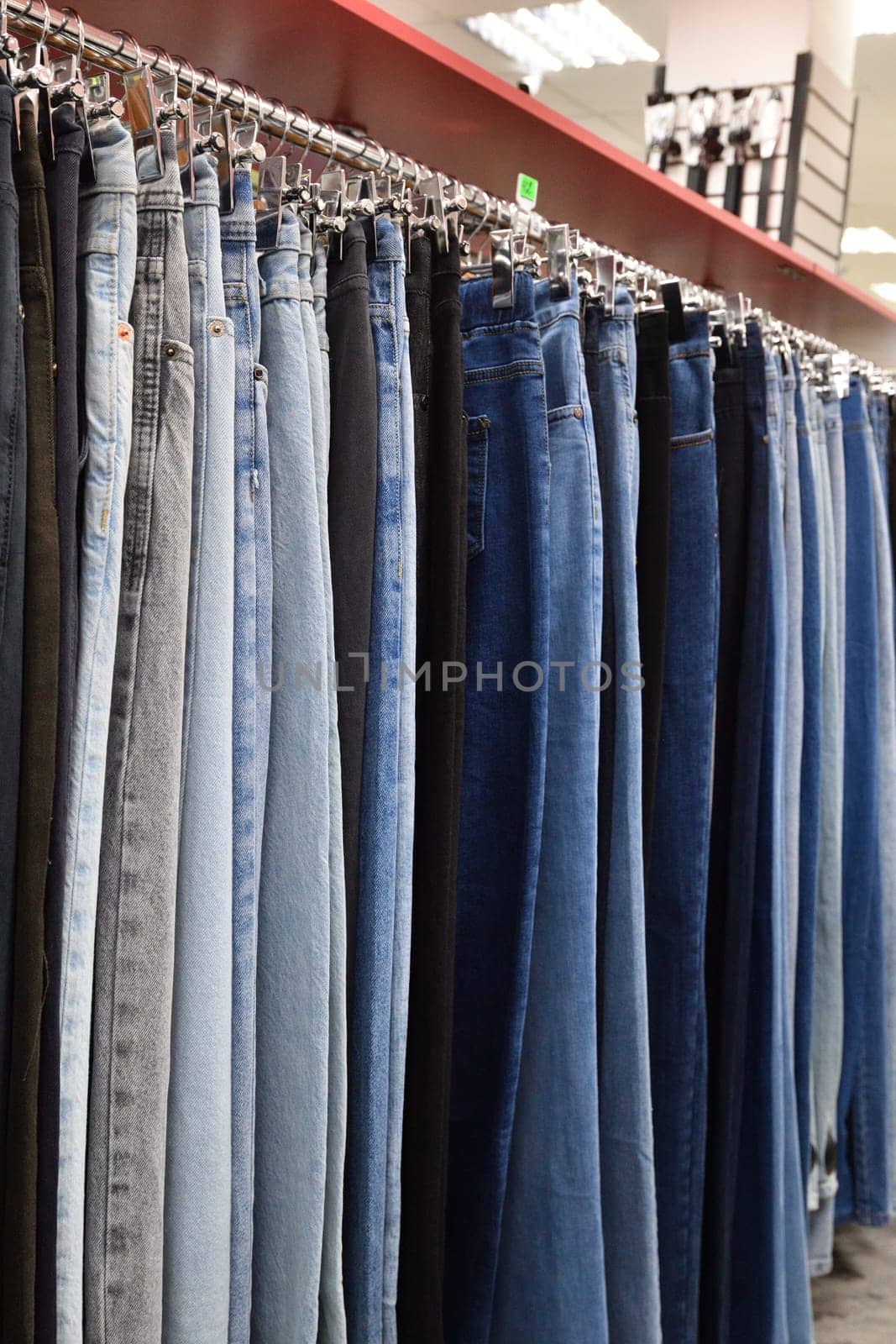 Jeans hanging in row in a store