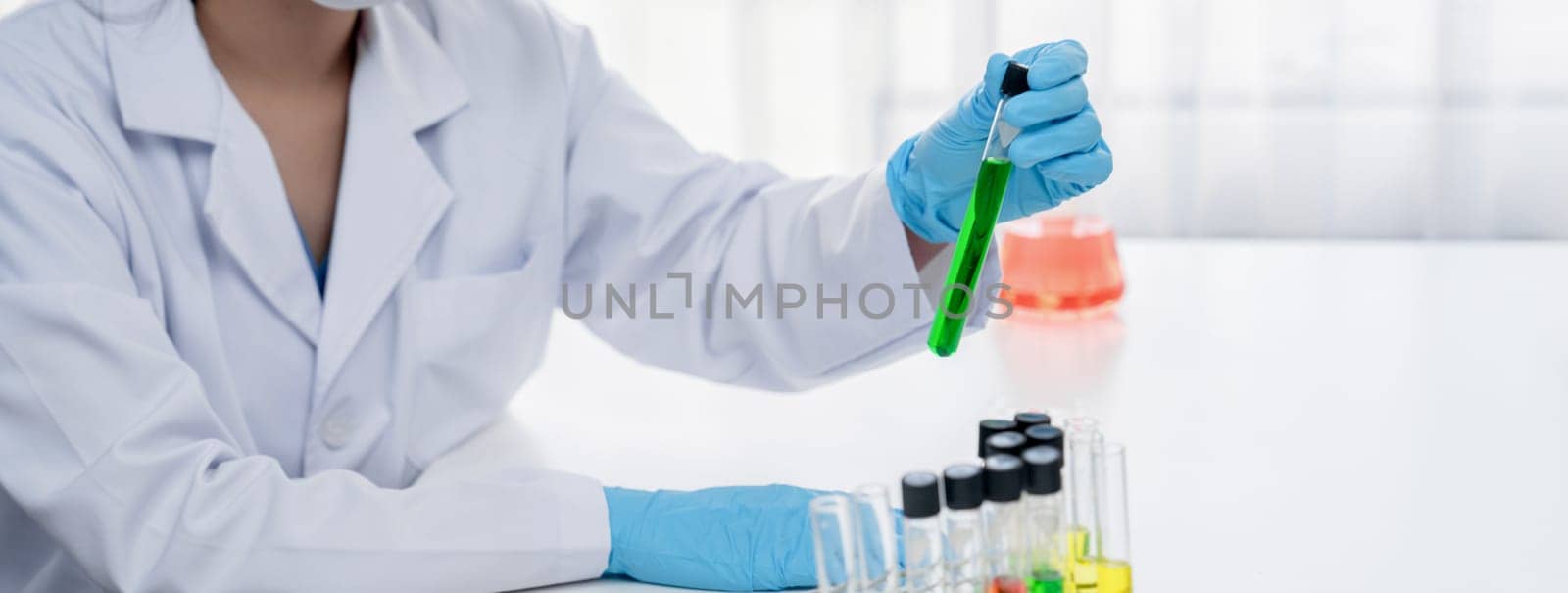 Laboratory researcher develop new medicine or cure using colorful chemical liquid in lab tube. Technological advance of healthcare with scientific expertise with laboratory equipment. Panorama Rigid