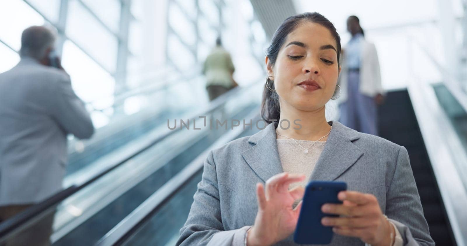 Business, escalator and travel with woman, cellphone and social media with accountant, employee and convention. Person, consultant or broker with a smartphone, airport and connection with digital app by YuriArcurs
