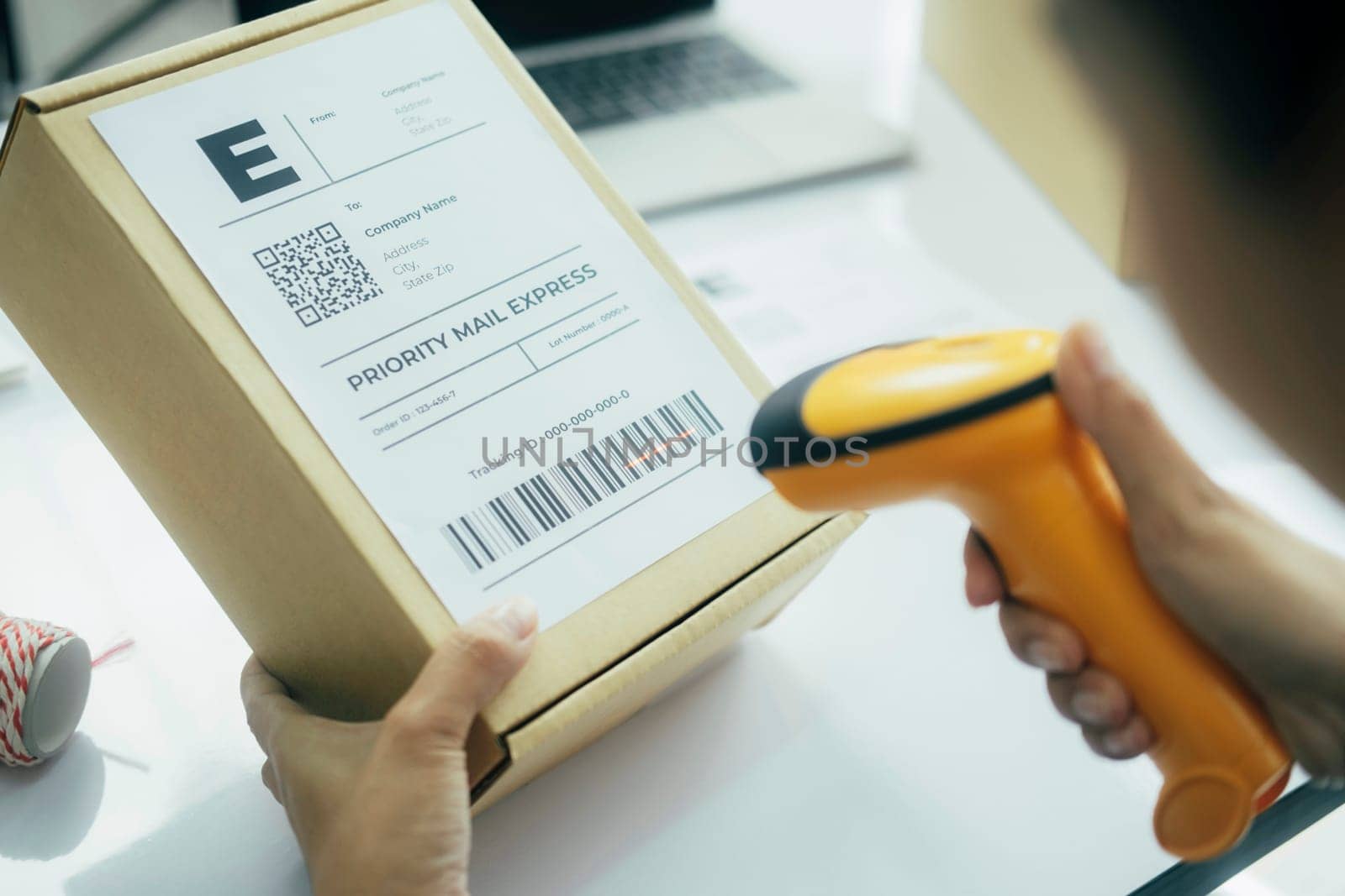 Female seller worker online store holding scanner scanning parcel barcode tag packing ecommerce post shipping box checking online retail store orders in dropshipping delivery service warehouse.