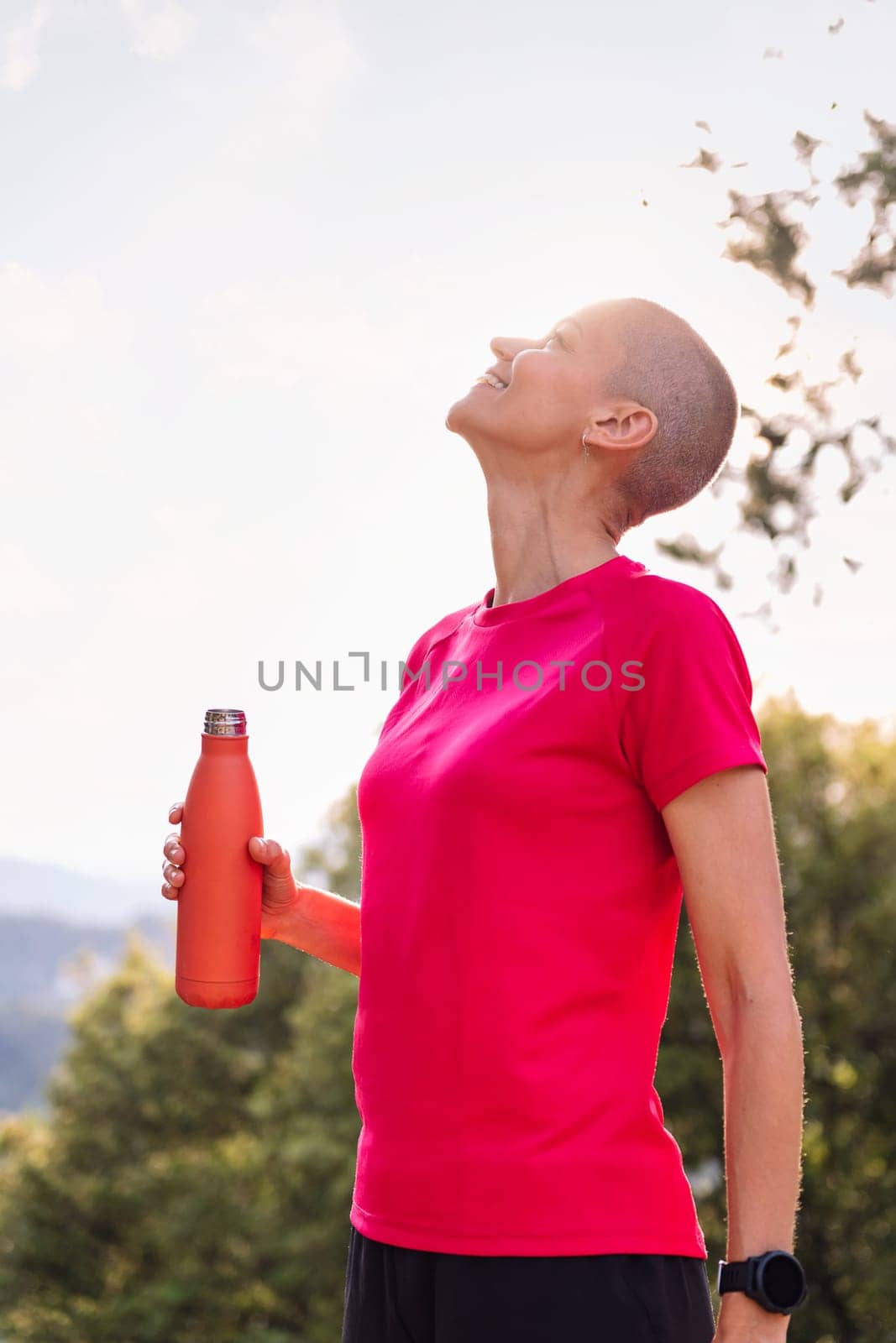 woman drinking water during her training, concept of sport in nature and healthy lifestyle, copy space for text