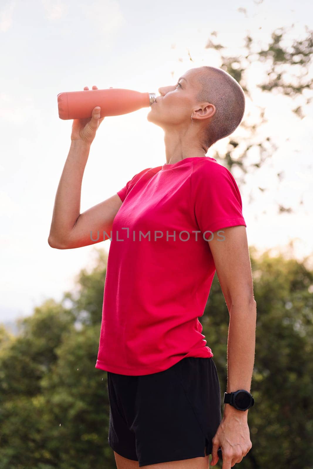 woman drinking water during her training, concept of sport in nature and healthy lifestyle