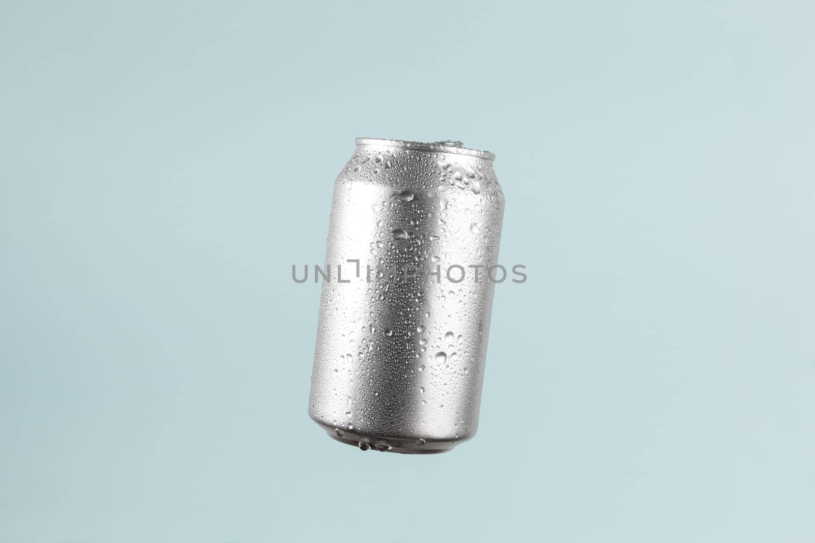 Aluminium beer or soda drinking can on light blue background by TropicalNinjaStudio