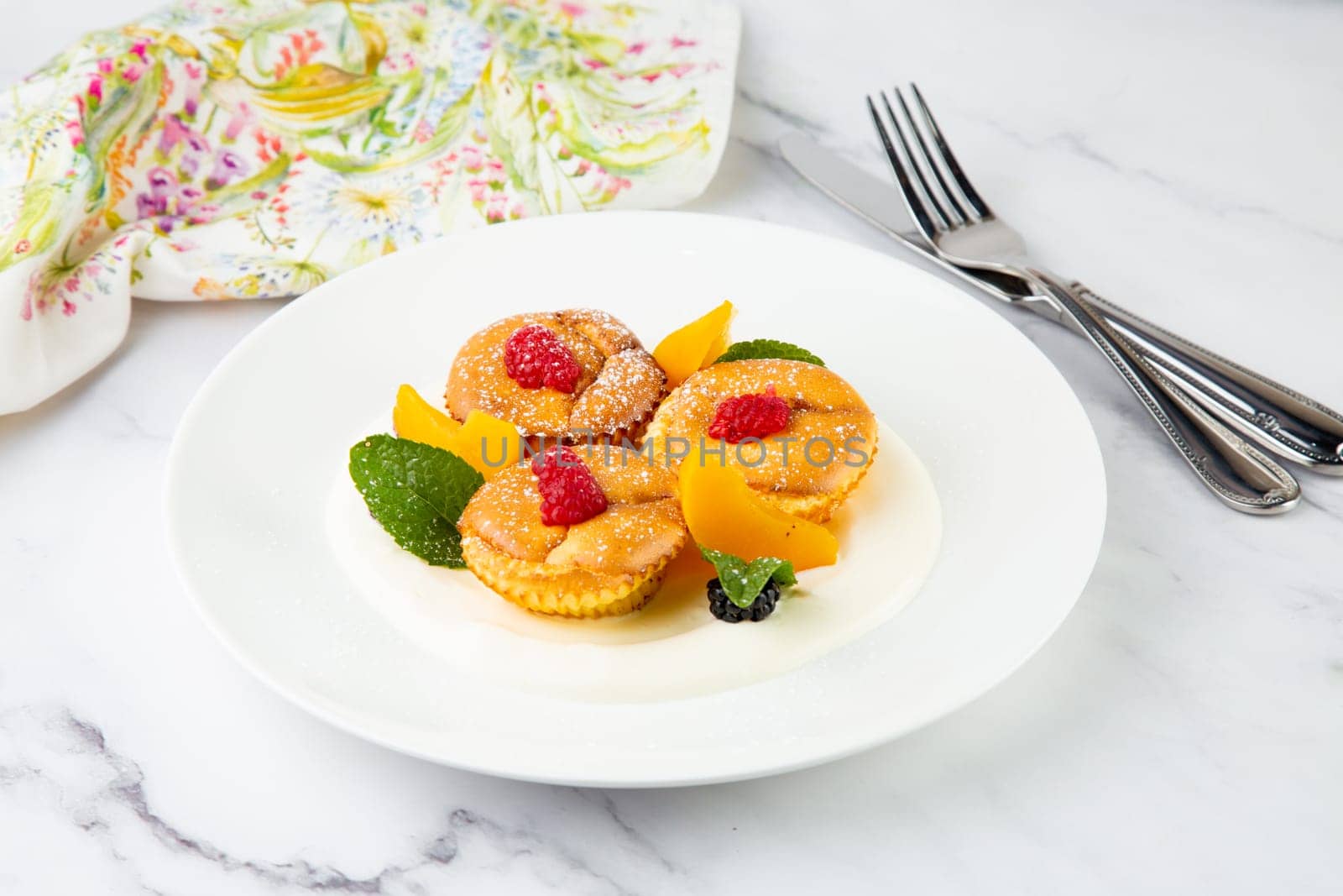 muffins with peach, raspberry, black berry and mint covered with powdered sugar