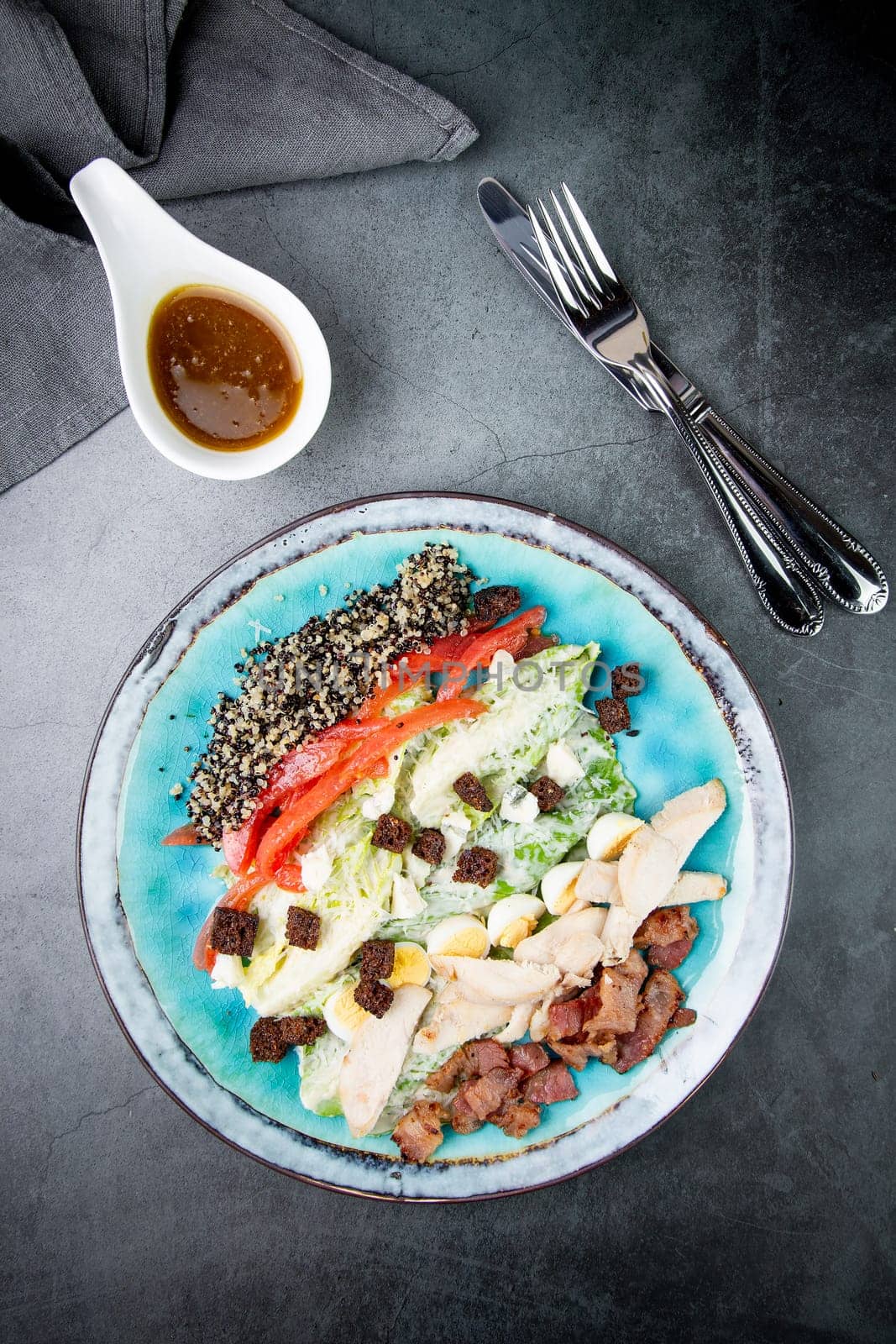 different types of meat, sesame seeds, greens and croutons