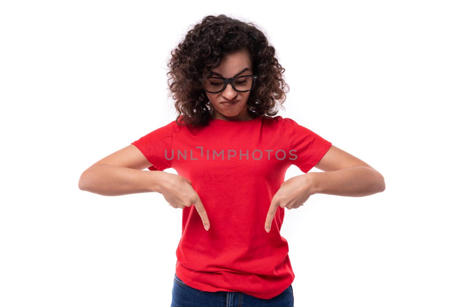 a young well-groomed woman in glasses for vision is dressed in a red basic T-shirt actively gesturing pointing with her hands.