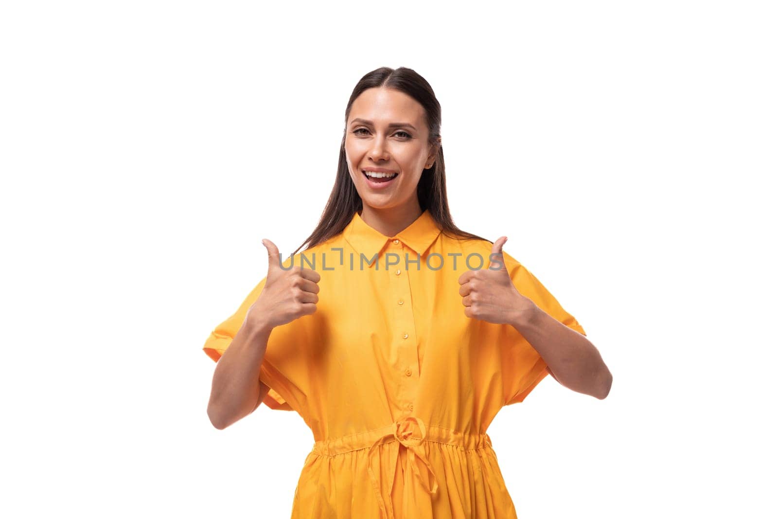 european young woman with black hair dressed in an orange summer dress is inspired by an idea and wants to talk about it.
