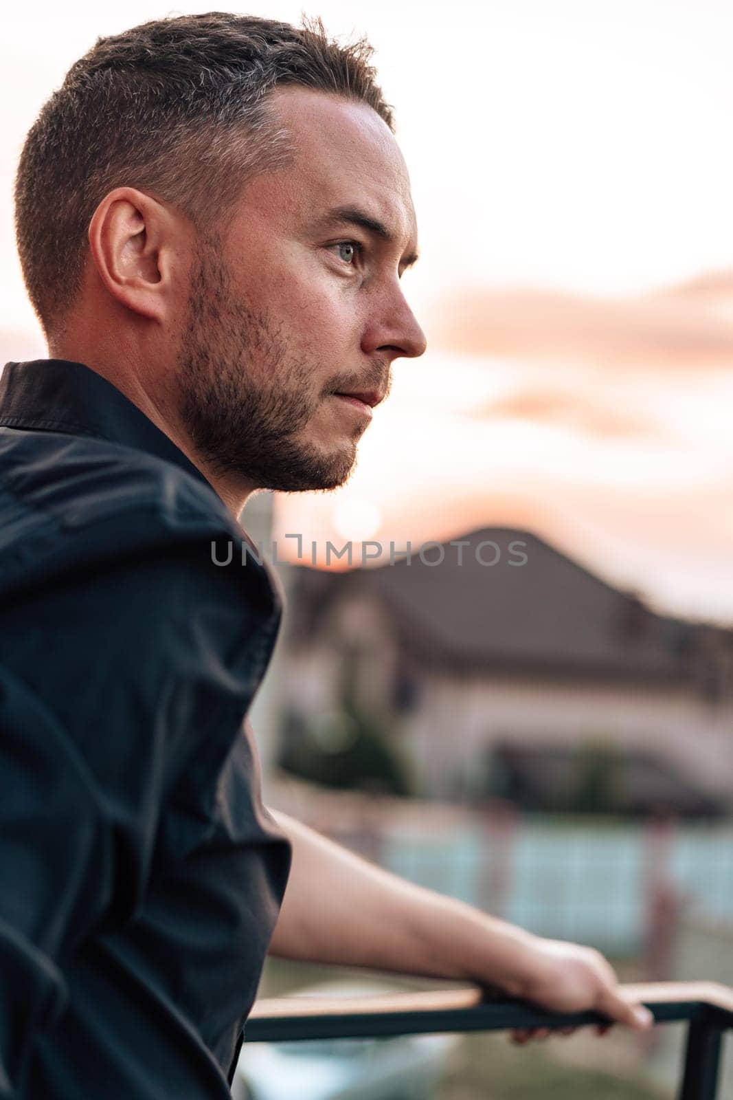 Portrait of handsome successful man standing outdoors close up