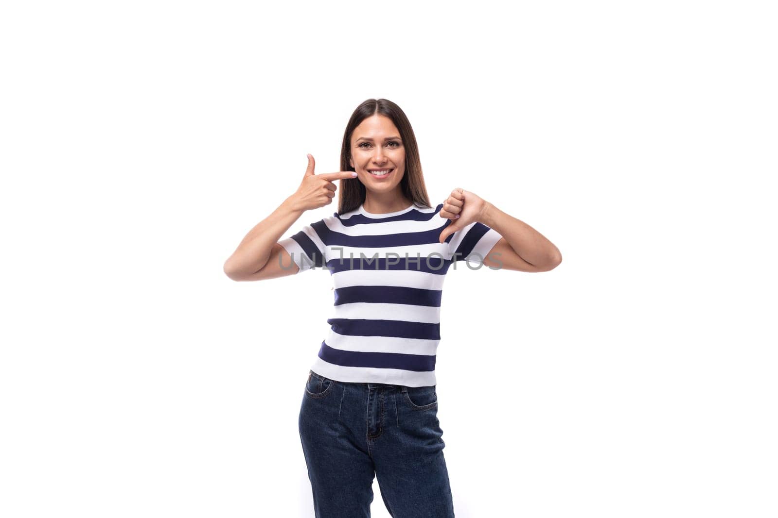 pretty slim young brunette woman in a striped t-shirt on a white background with copy space.
