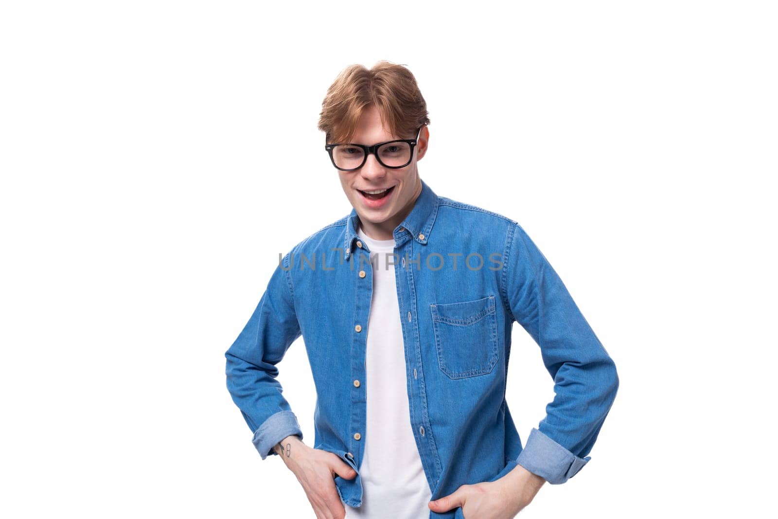 young handsome european man with copper hair dressed casually against the background with copy space by TRMK